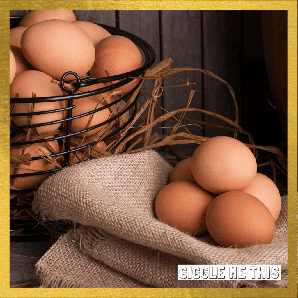 Eggs in a basket and a few sitting on a folded cloth, a gold boarder is on the outside of the picture and a logo of giggle me this on the bottom right.